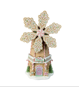 Decorative gingerbread windmill with intricate details on a white background
